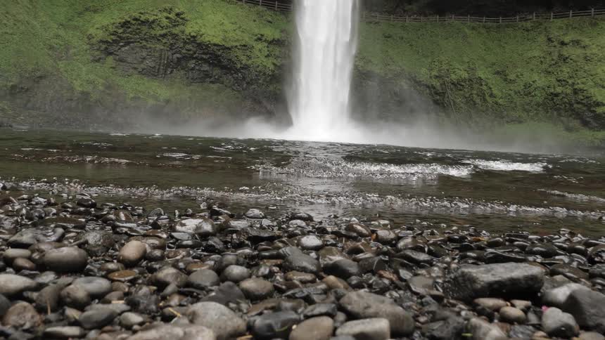 Waterfall pouring water into a small lake