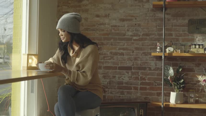 A woman takes a sip from a cup
