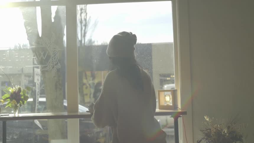 A woman taking a sip of coffee