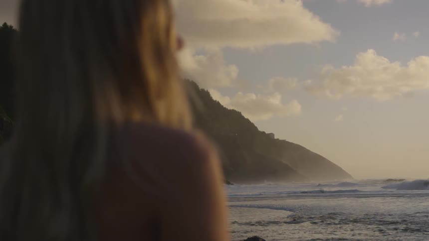 Woman looks out over the ocean