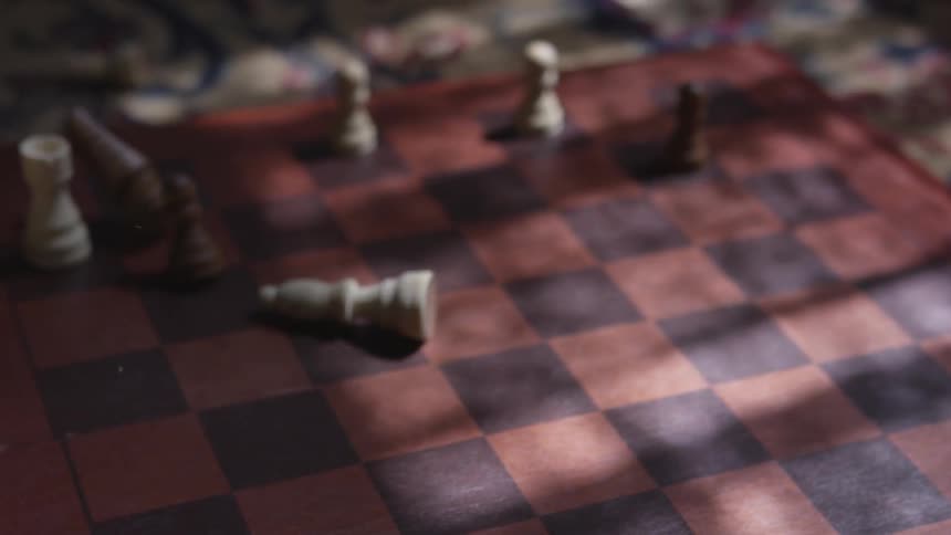 Someone tosses the pieces off of a chess board