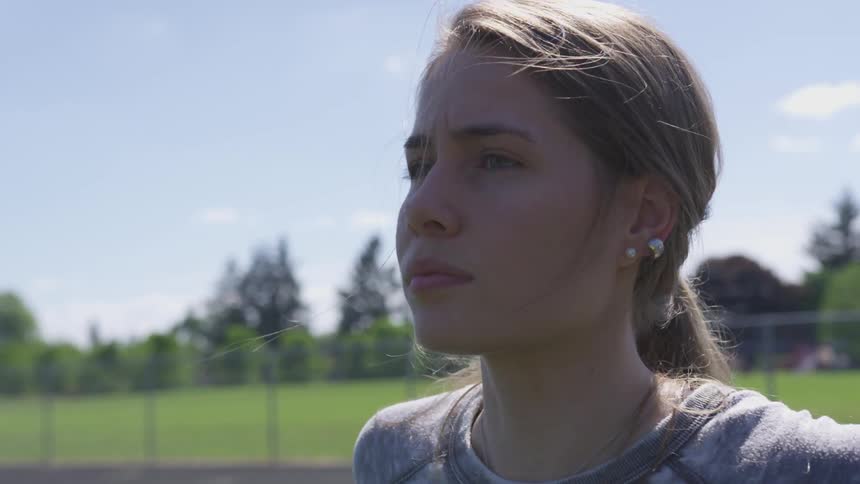 Young girl warms up on a running track