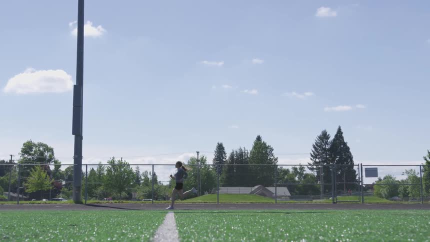 Girl runs across running track