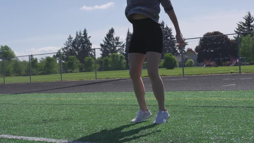 A woman jumping on a field