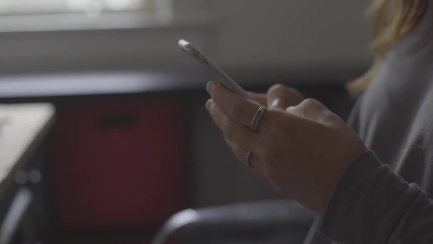 Woman typing on cell phone