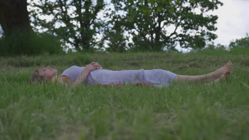 White woman lying on the grass