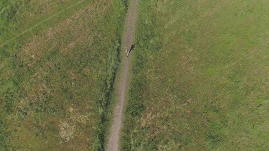 A person running along a dirt road