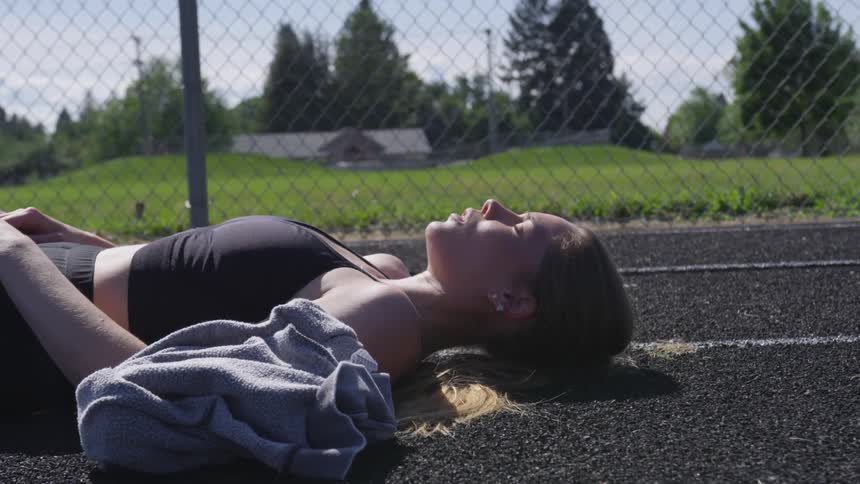 Girl laying down on a track