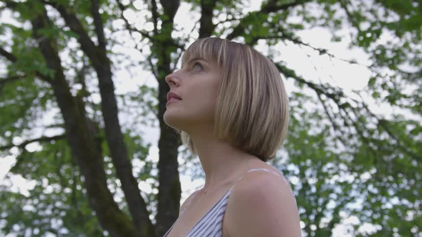 A woman standing outside looking up at the sky