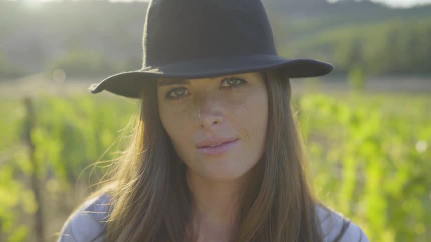 A woman is outdoors smiling