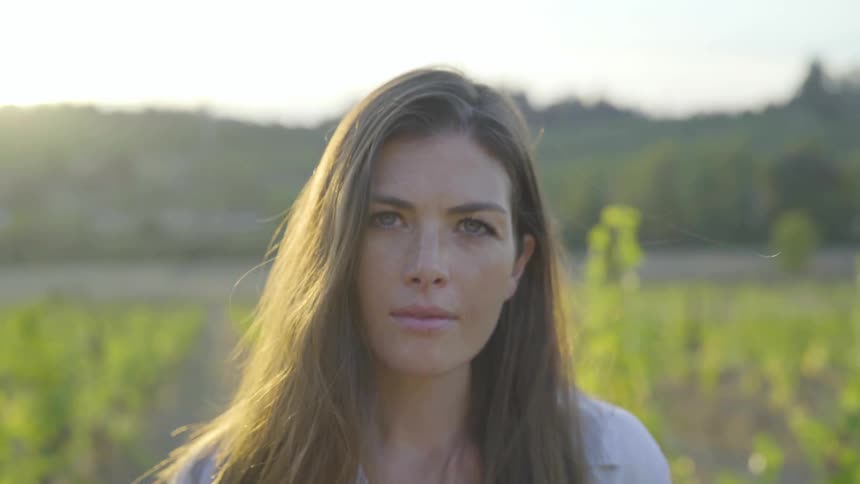 A woman is outdoors in a rural area