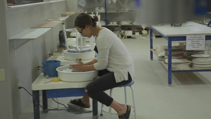 Woman molding clay