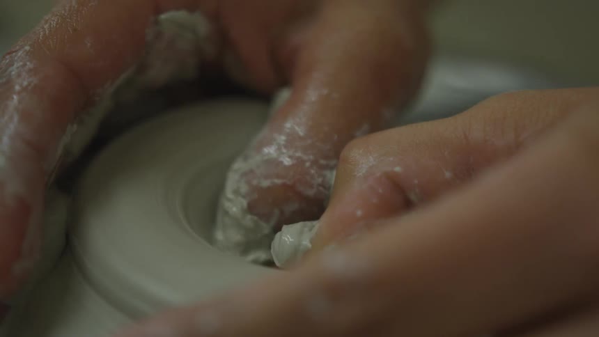 A person molding clay