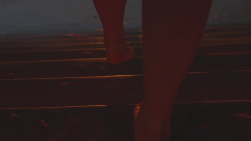 A woman is climbing concrete stairs