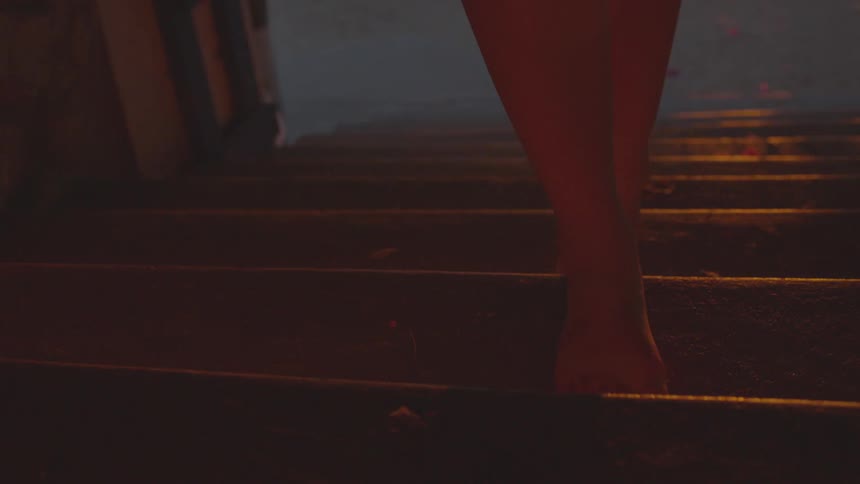 Person walks barefoot up stairs