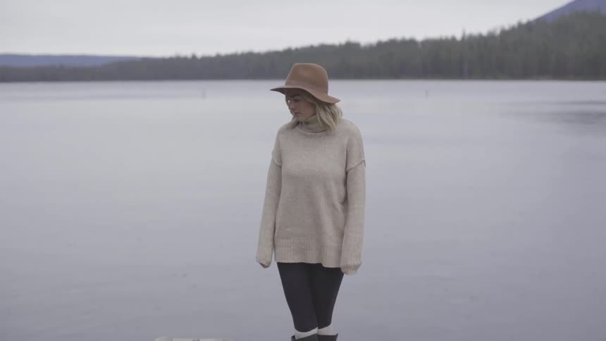 Girl standing next to lake