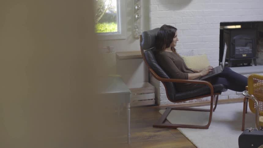 Girl sitting in a chair looking at a computer