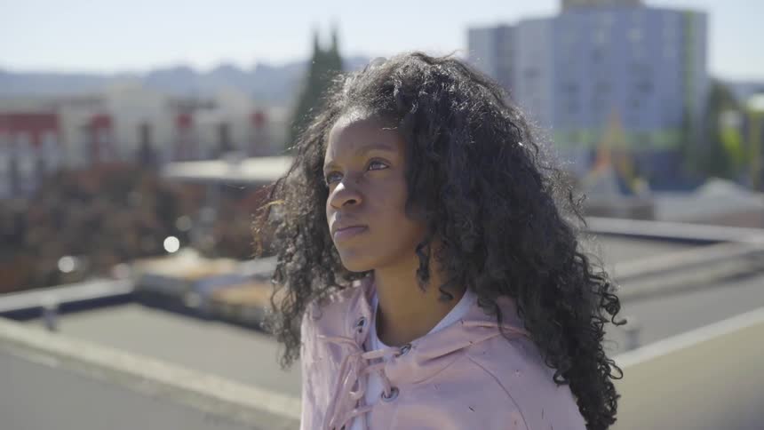 A woman is outdoors looking around