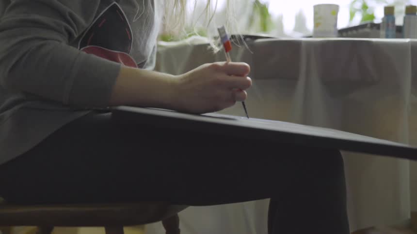 Woman painting on a canvas