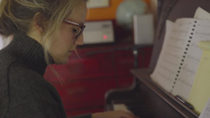 A woman plays the piano