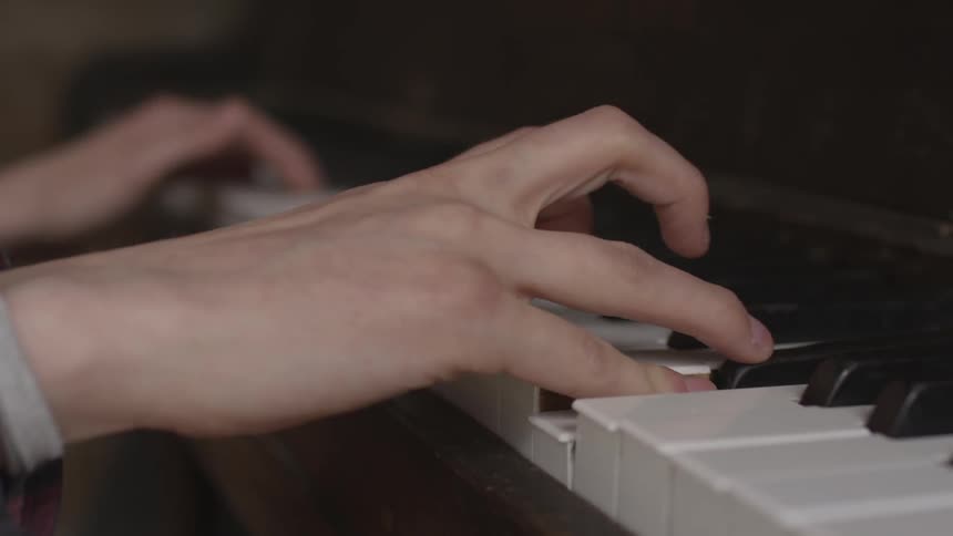 A person pressing keys on a piano