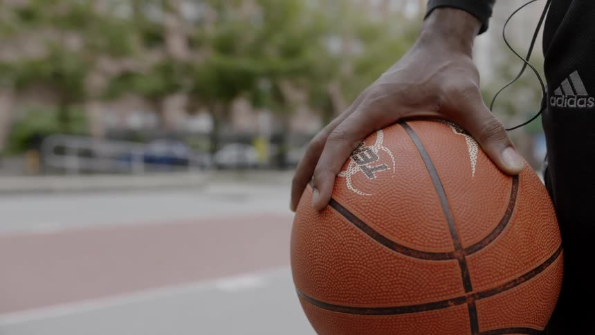 A man holds a basketball