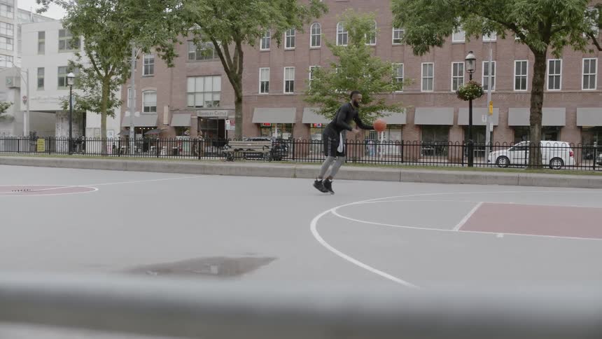Man dribbles basketball and takes a shot