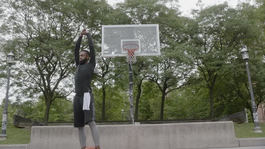 A man stretches on the basketball court