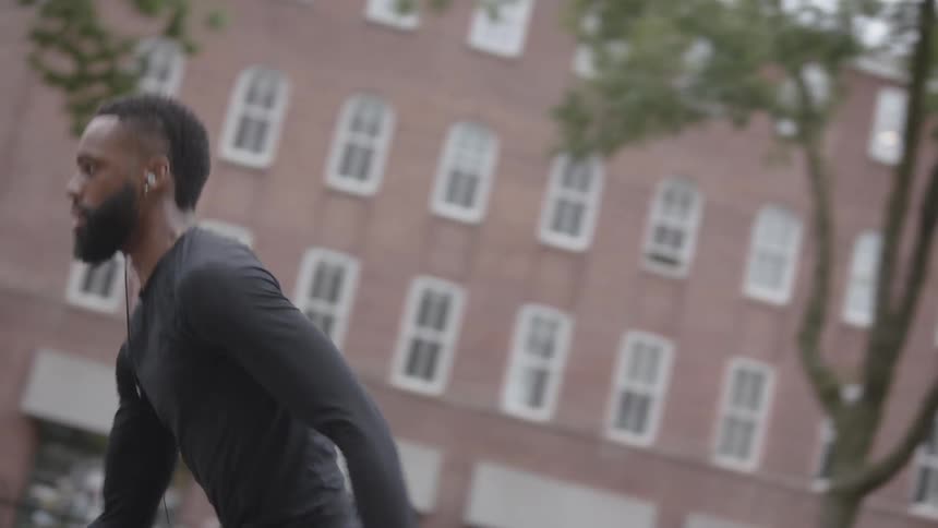 A man runs to take a basketball shot
