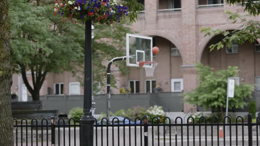 African american man makes three point shot on outdoor basketball court