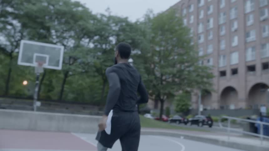 Man runs across a basketball court
