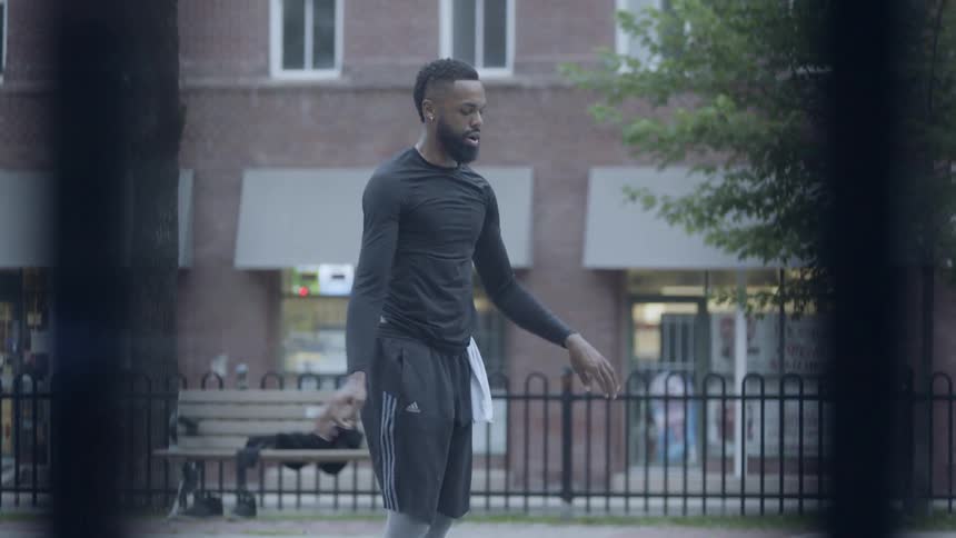 Man doing burpee on basketball court