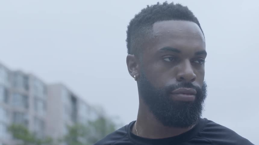 A black man looks around in the city