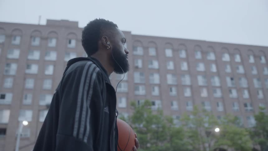 Man walking holding a basketball