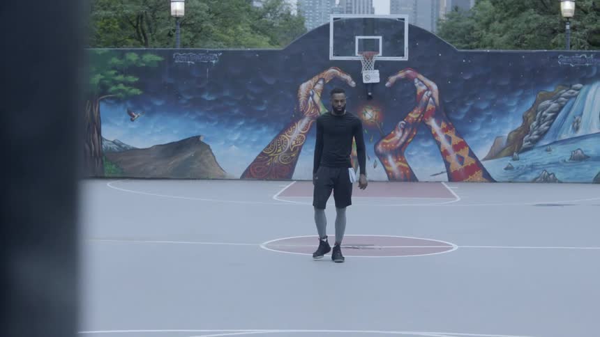 Black man walking on a basketball court