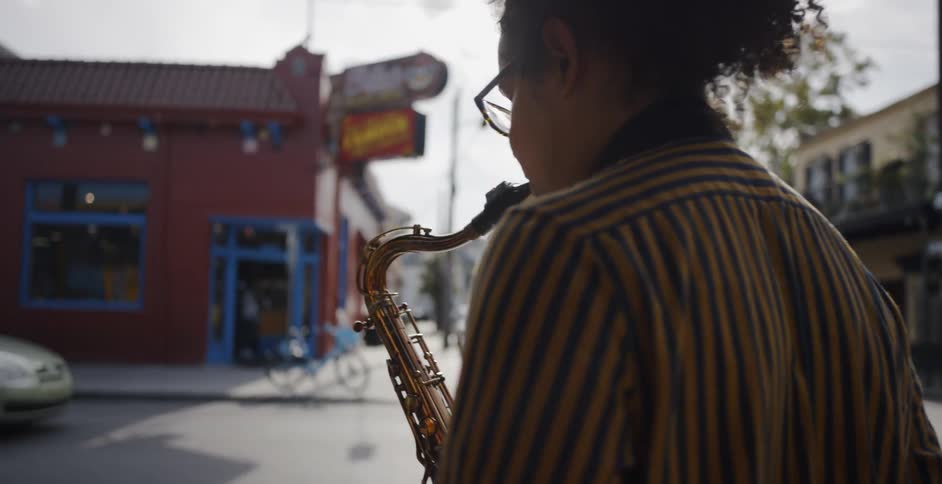 Man playing the saxophone on the streets of a town