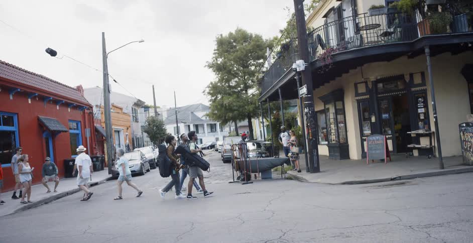 A group of people cross the street