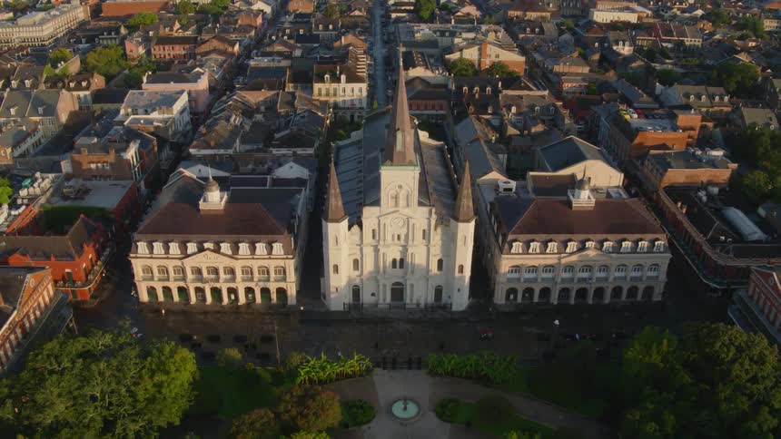 A aerial view of a large cathedral and the surrounding community
