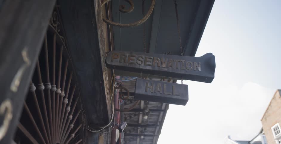 The camera looks up on the sign on an old building