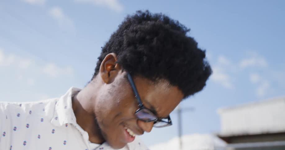 A black man with glasses nodding and smiling