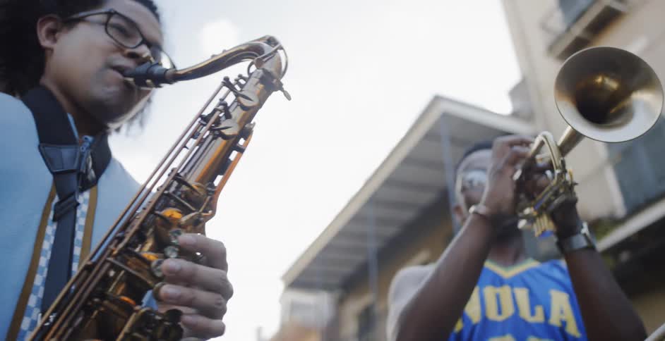 Black men playing wind instruments in the street