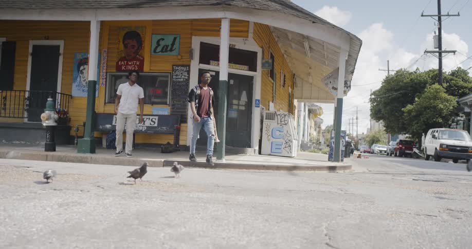 People walking off a sidewalk into a street