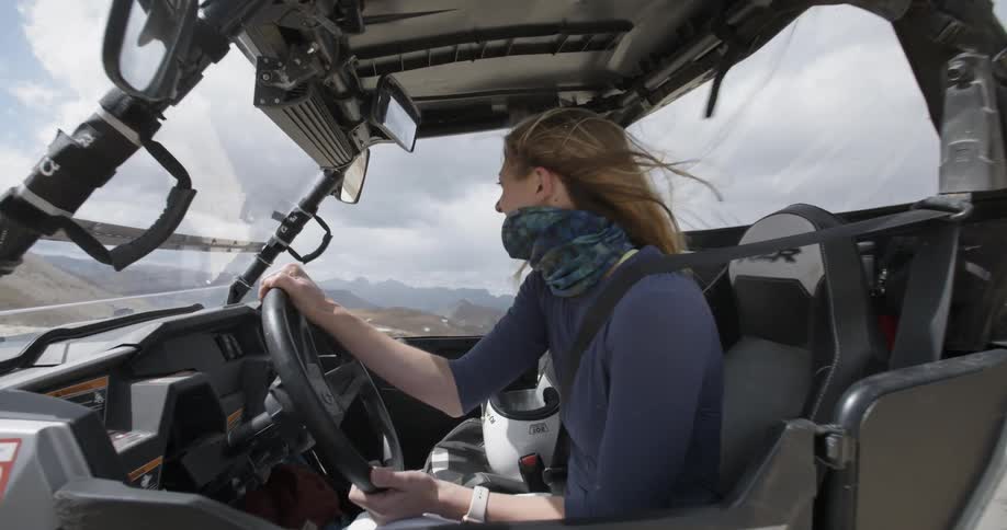 A woman sits in a off road vehicle