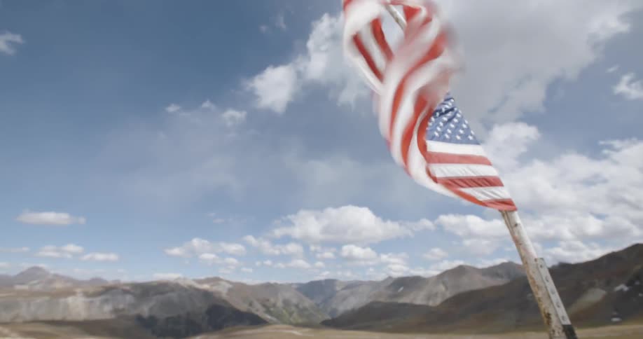 A close up of the american flag flying at half mast