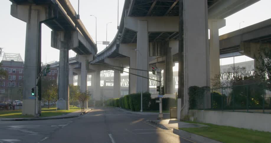 A road underneath a highway overpass in the daytime
