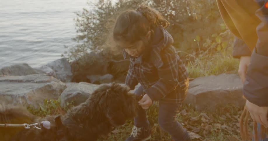 Mom and child feeding a dog