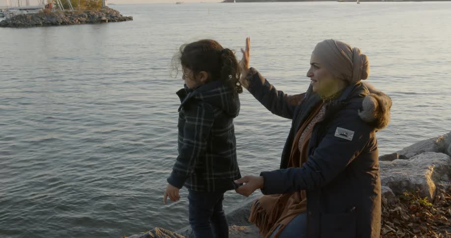 A woman and child waving