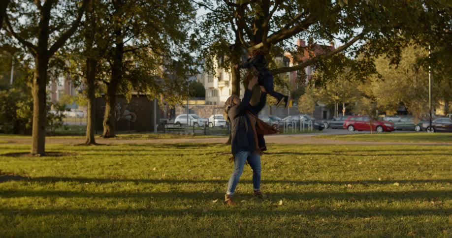 A little girl runs towards a woman in an open field