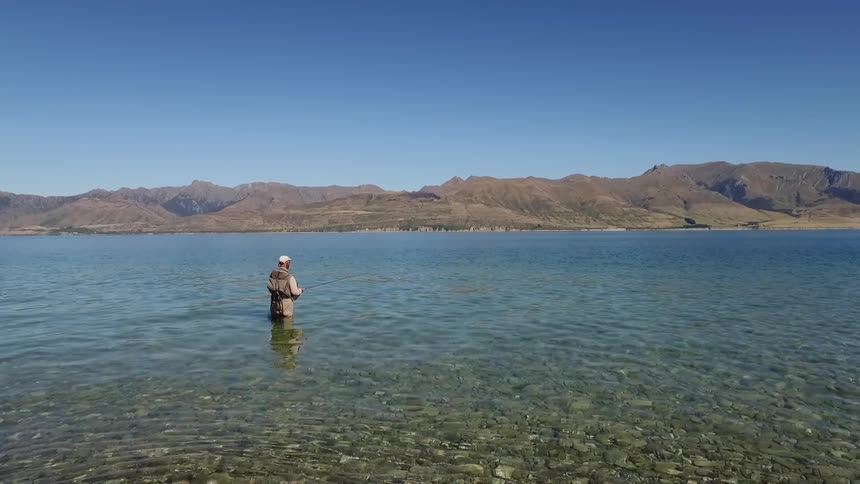 Man Fly Fishing At Lake Hawea
