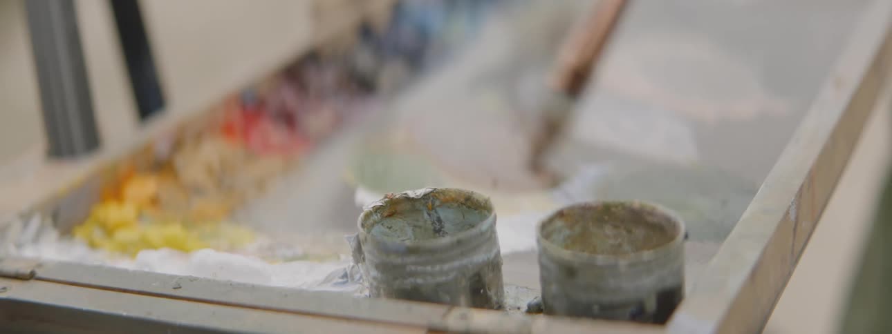 A paintbrush dipping into paint